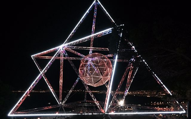 Large geometric light installation at night 