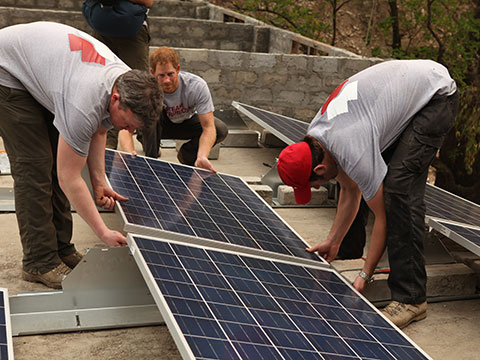 Prince Harry helping to install solar panel